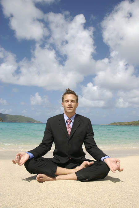man-doing-yoga-in-business-suit-on-beach